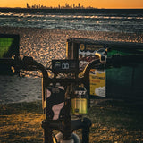 Bicycle with a bottle of Fizz7 on a beach at sunset