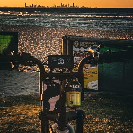 Bicycle with a bottle of Fizz7 on a beach at sunset
