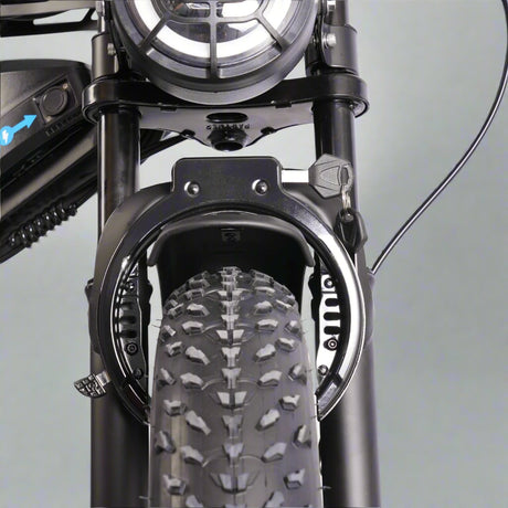 Close-up of a bicycle's front wheel and suspension fork on a white background