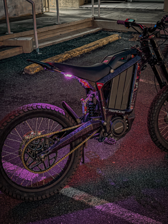 Electric Dirt Bike with purple accents on a dark surface