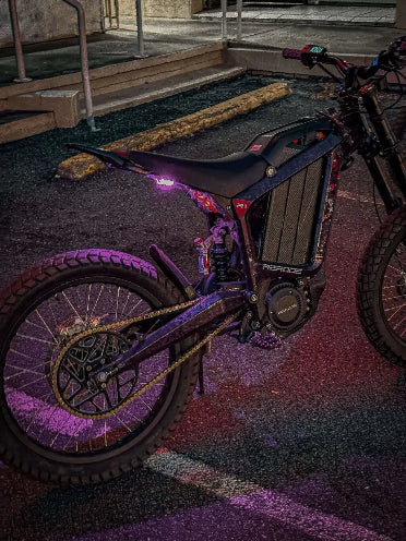 Electric Dirt Bike with purple accents on a dark surface