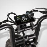 Digital speedometer on a bicycle handlebar with visible brand name.