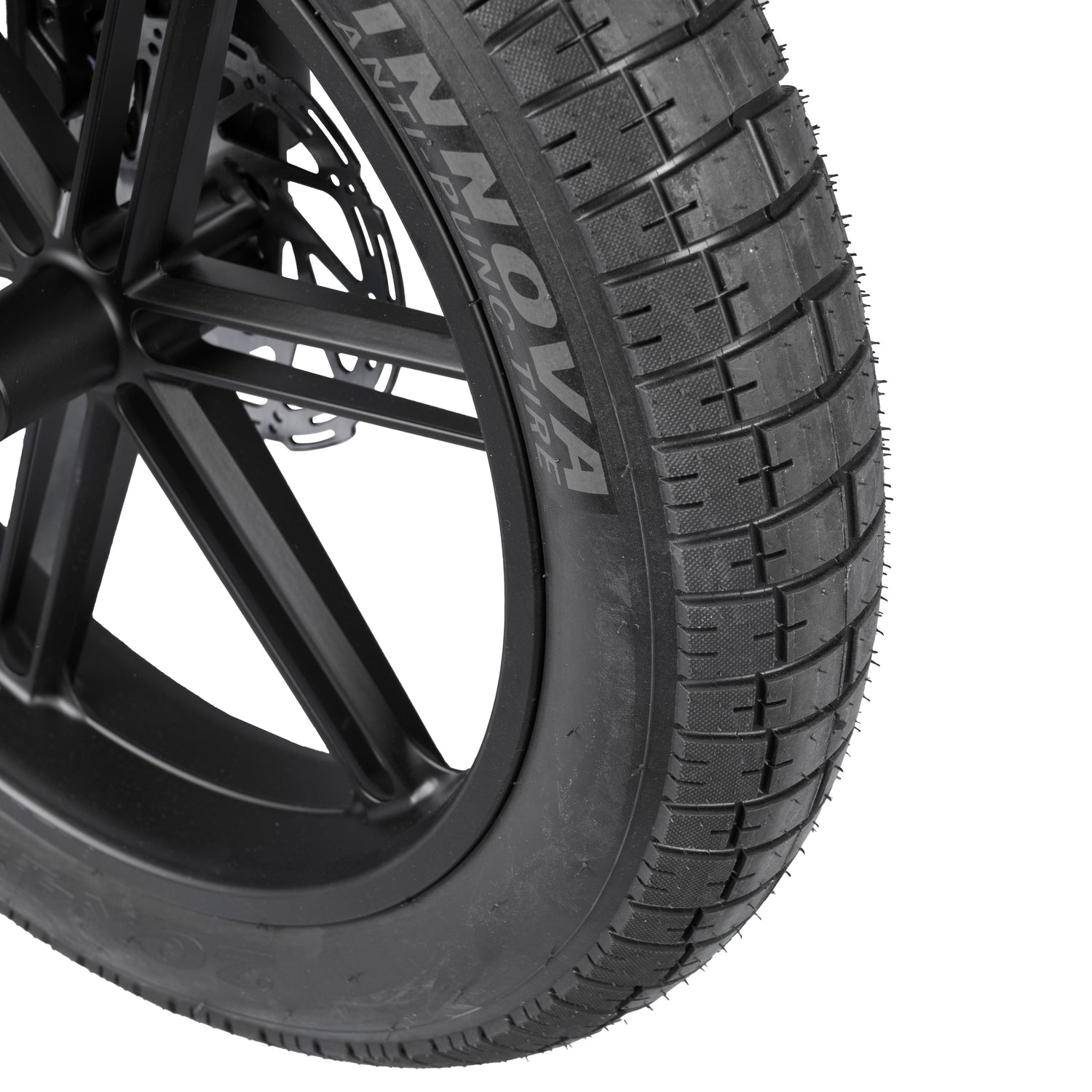 Close-up of a car tire with 'INNOVA' branding on a white background